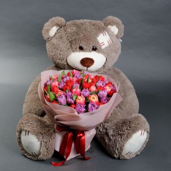 Bouquet of pink tulips and a teddy bear