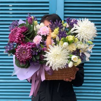 Arrangement in a basket with chrysanthemums and tulips